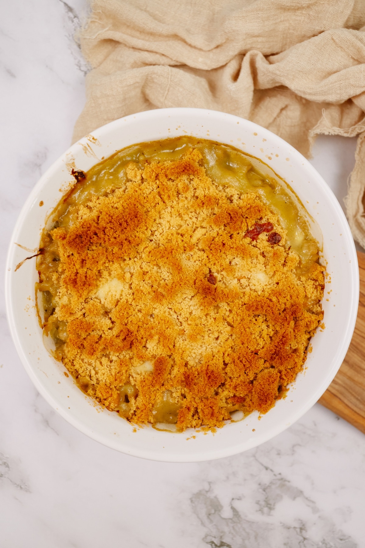 cabbage casserole baked in a round baking dish on a white marble surface