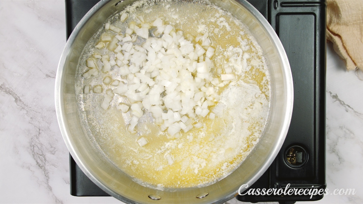 sautéing onions in a pan on a stovetop