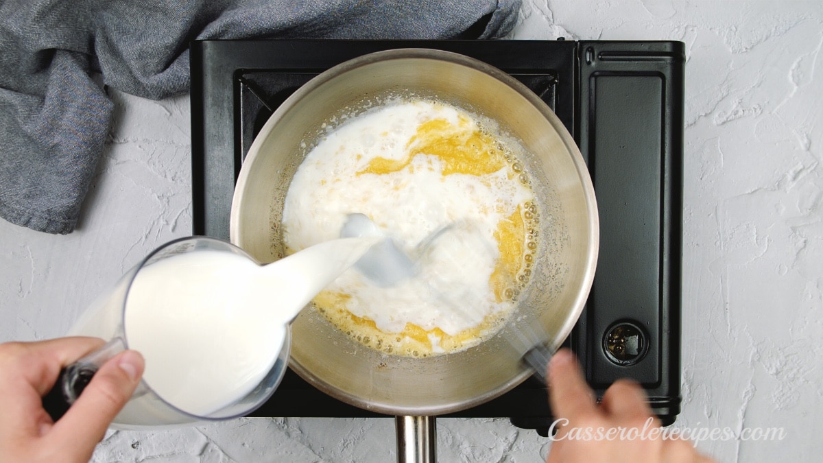 pouring milk into roux mixture