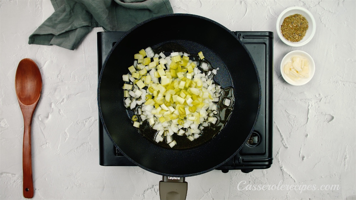 sauteing onions and celery in a pan