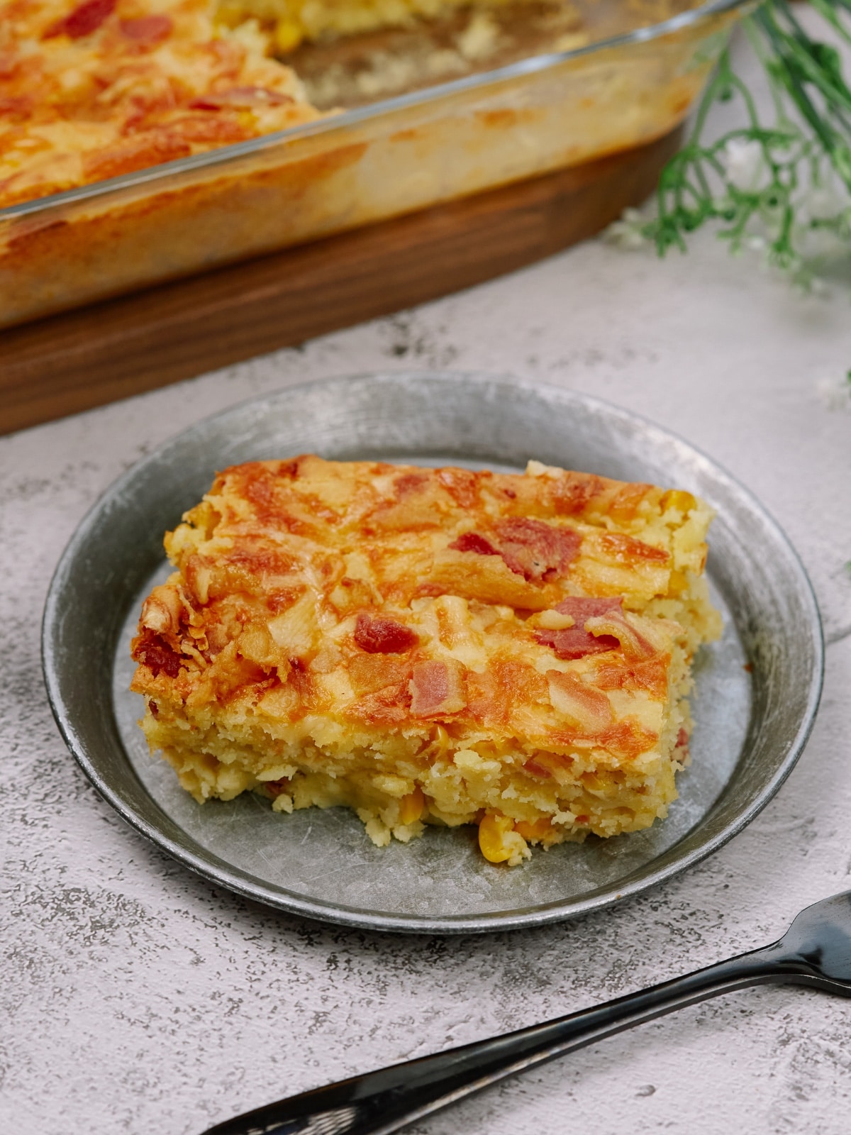 a square piece of cornbread casserole on a small plate