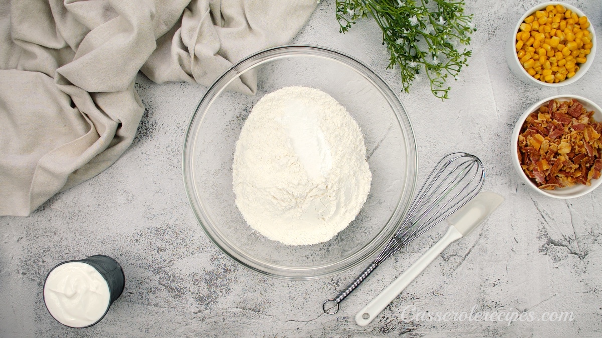 a large glass bowl filled corn meal and all-purpose flour