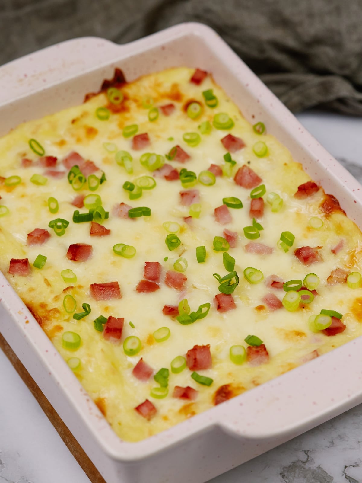 a baking dish of potato casserole slanted in the frame