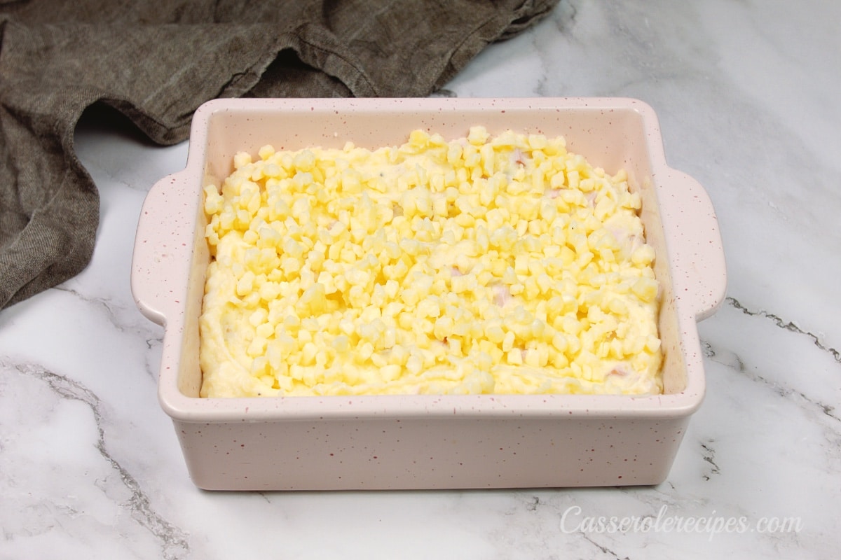 ham and potato casserole in a baking dish right before going into the oven