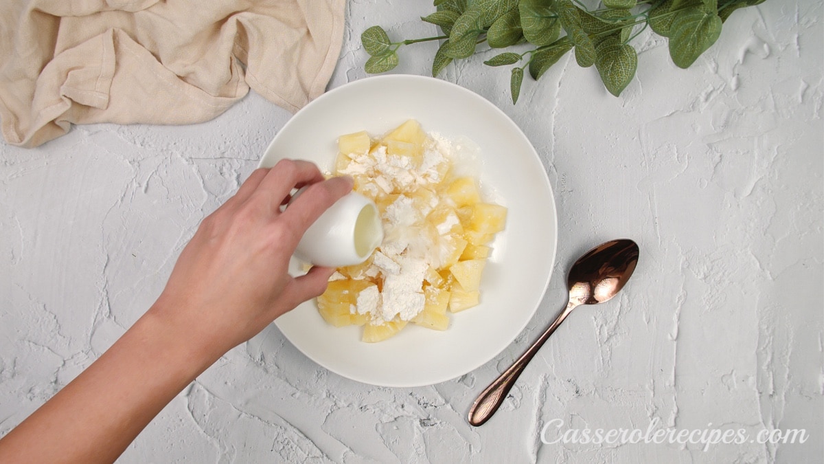 pouring reserved juice to the pineapple mixture