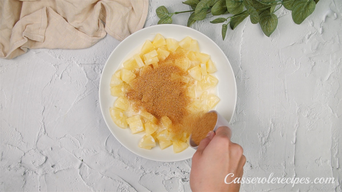 adding brown sugar to the pineapple mixture