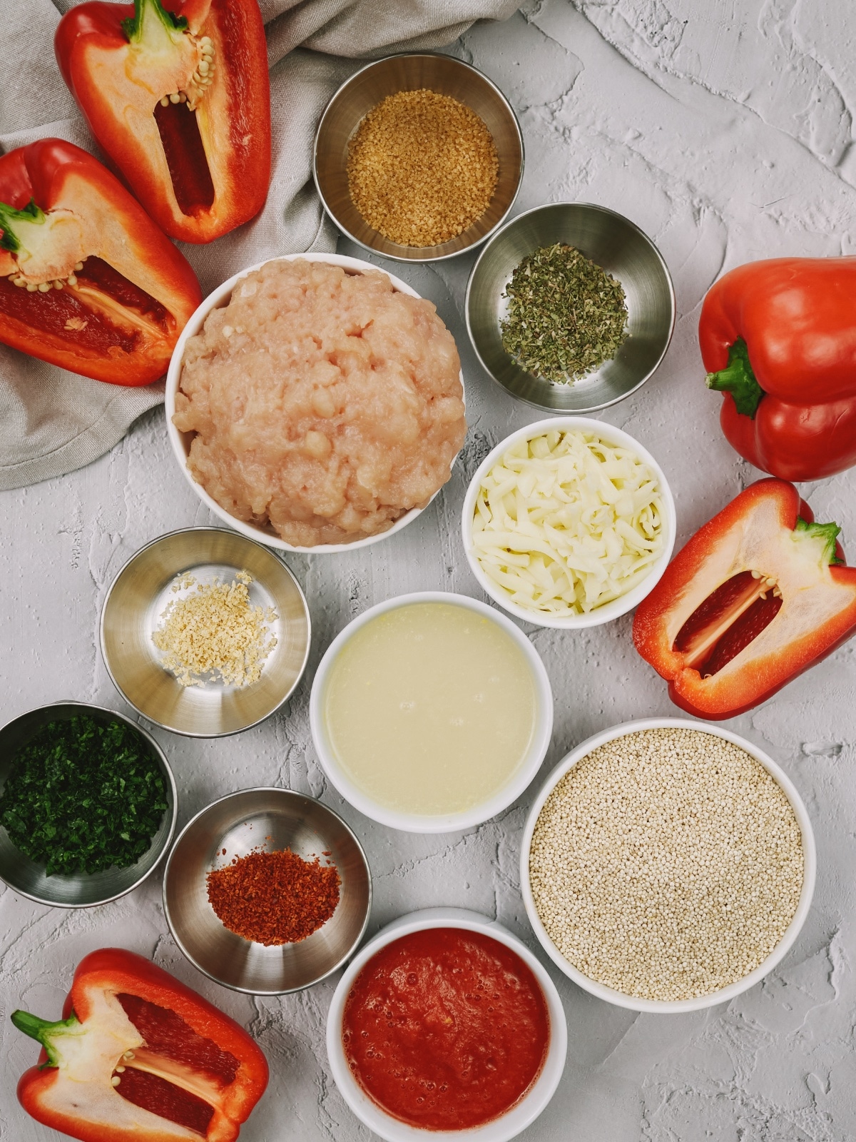 ingredients for stuffed pepper casserole in small bowls on a white surface
