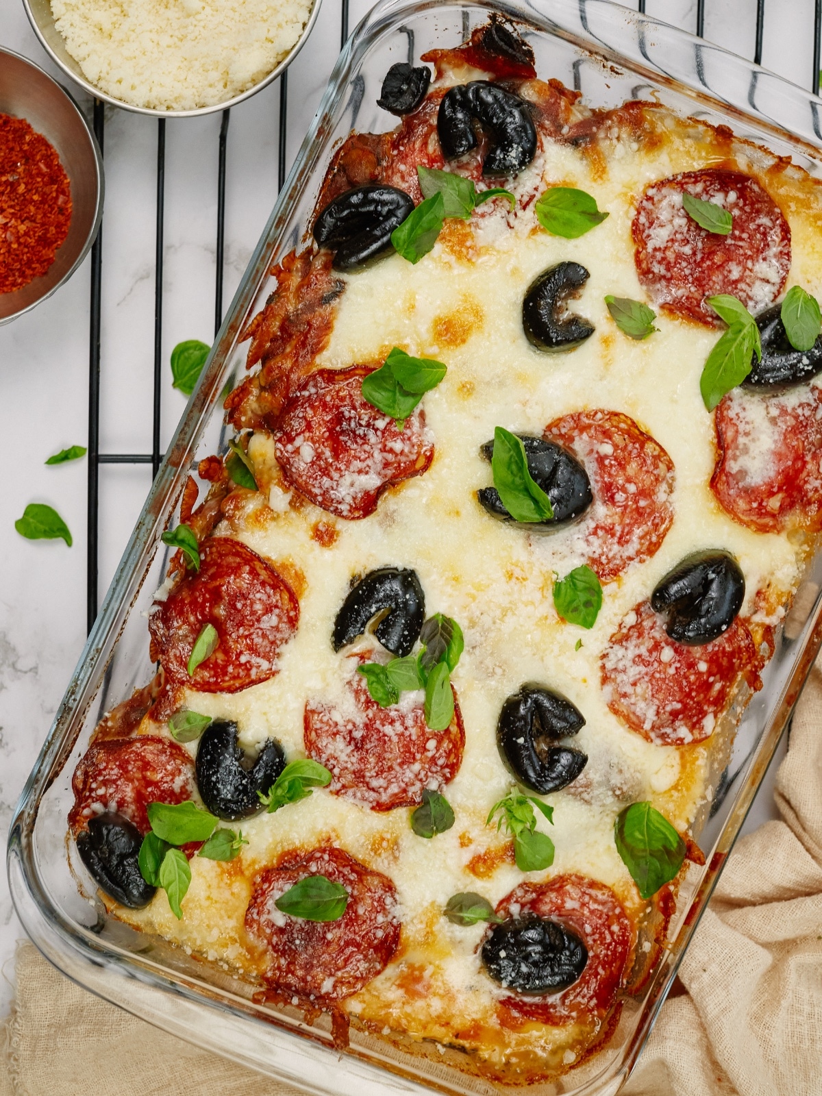 overhead view of pizza casserole in a dish sitting on a baking rack
