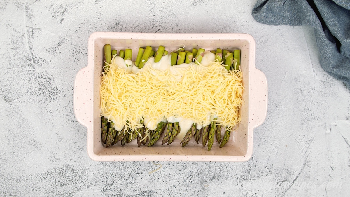 cheese topping the sauce and asparagus