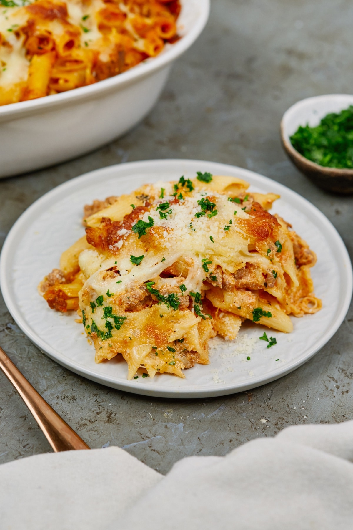 a serving of baked ziti casserole on a white plate