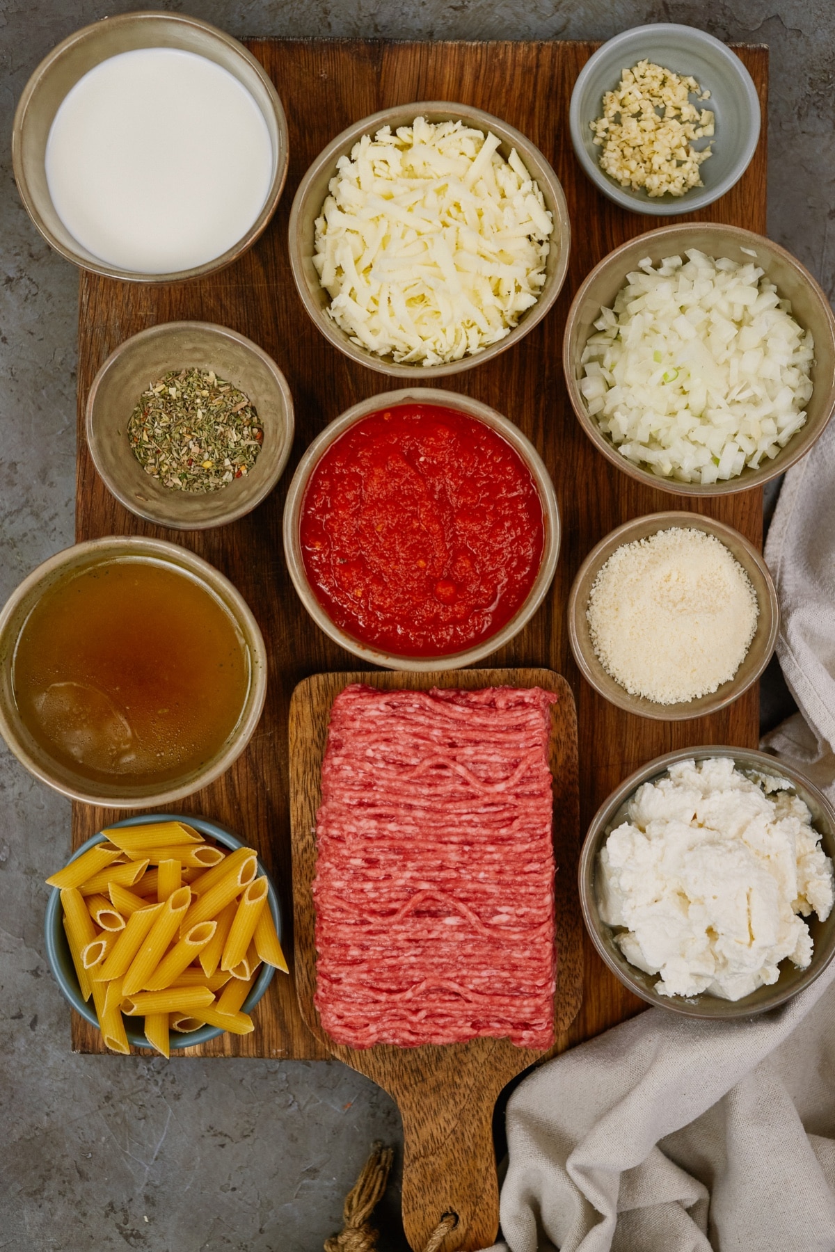 ingredients for baked ziti casserole in small bowls