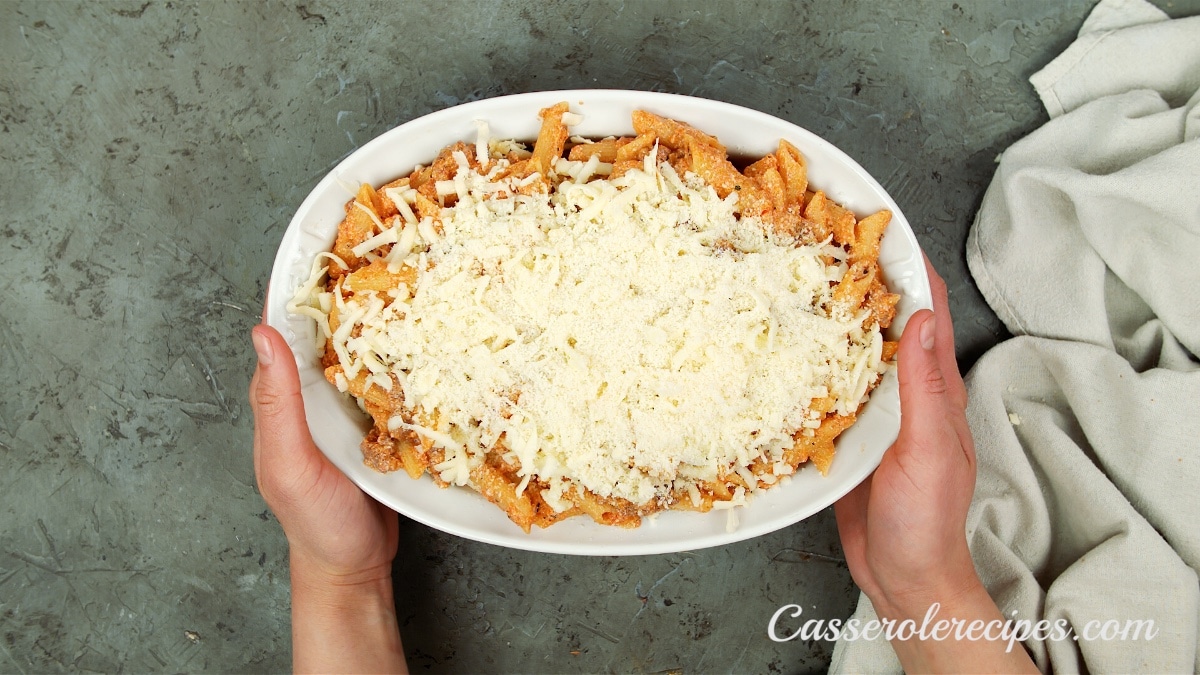 more pasta and cheese layered in the baking dish