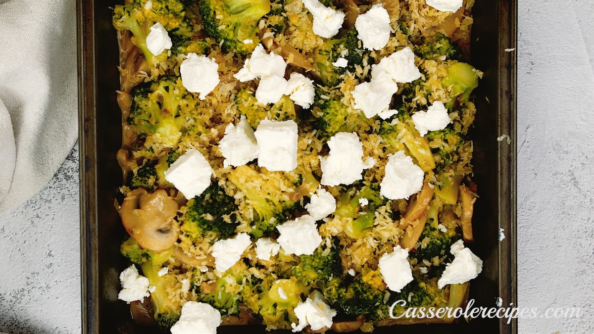broccoli mixture in a baking dish topped with cheese chunks