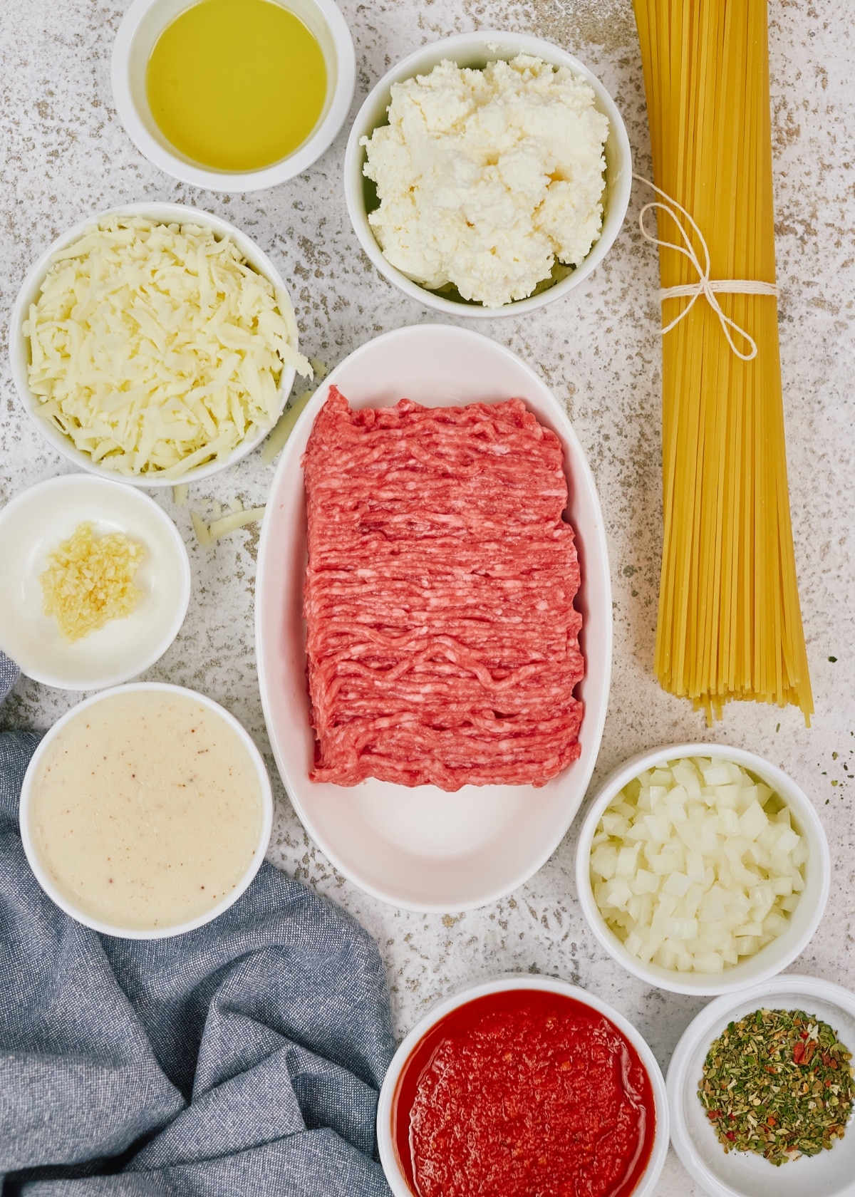 ingredients for spaghetti casserole in small bowls