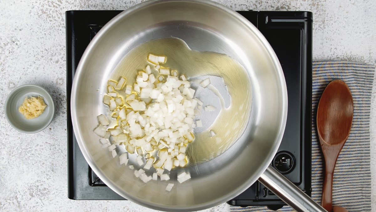 onions cooking in a pan on a stovetop