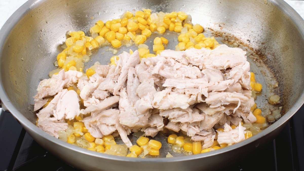 chicken added to pan with corn and onions