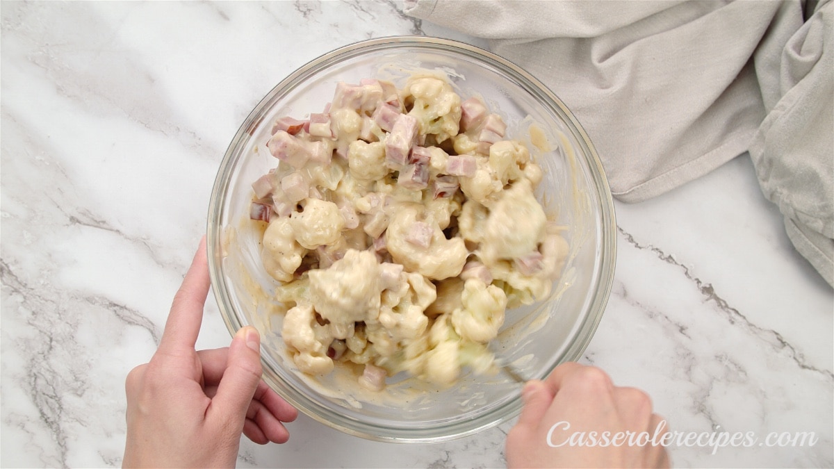 ham and cauliflower mixed together in a glass bowl