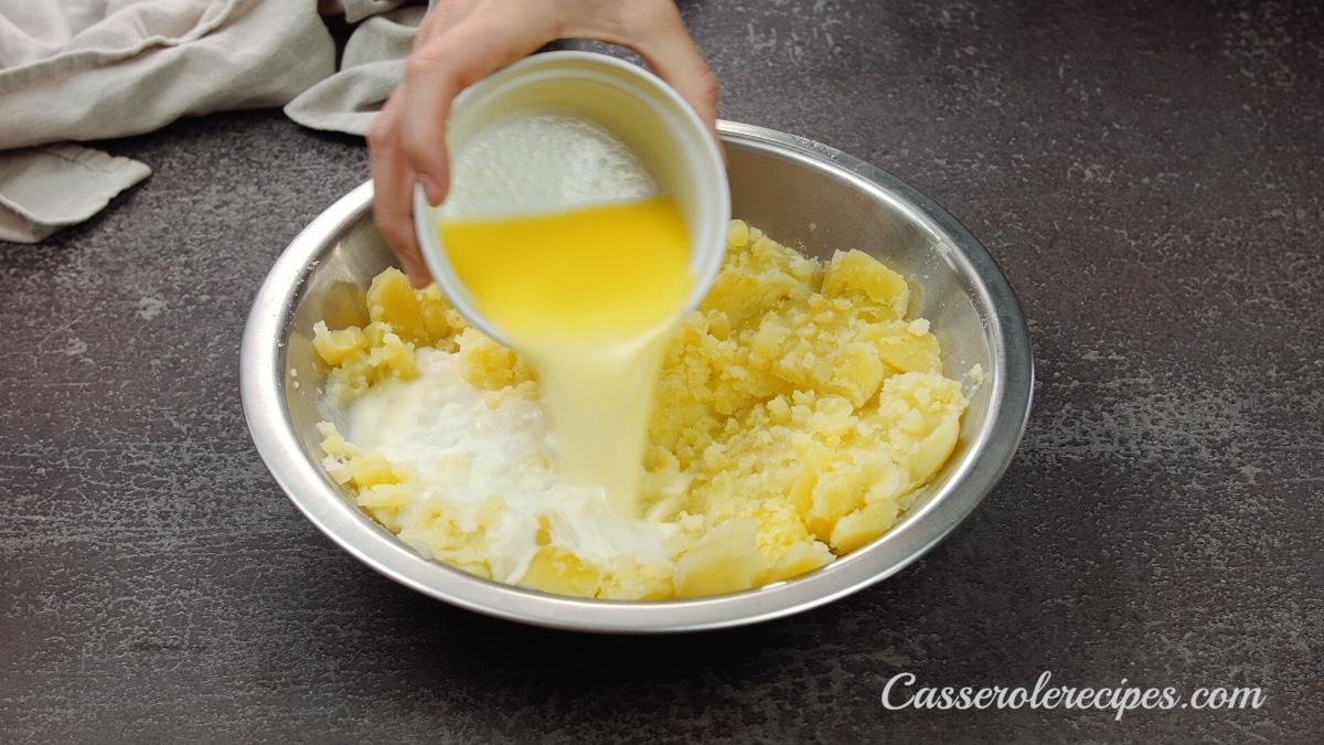 pouring liquid in mashed potatoes