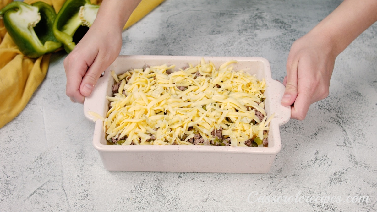 cheese topping meat mixture in a baking dish