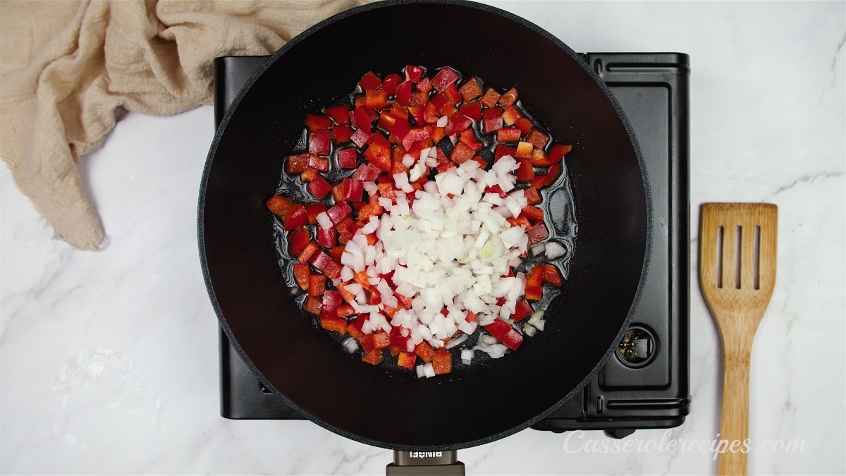 red bell peppers and onions in skillet