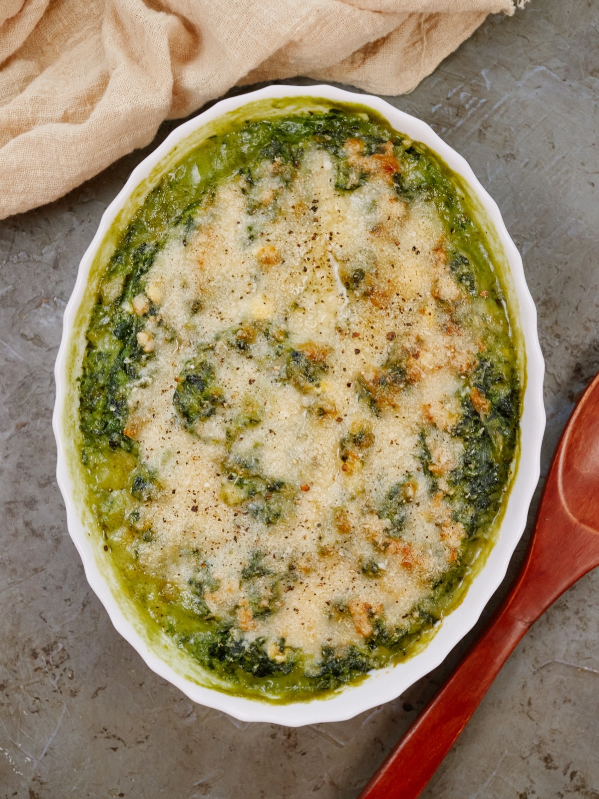 a baking dish with cooked spinach casserole