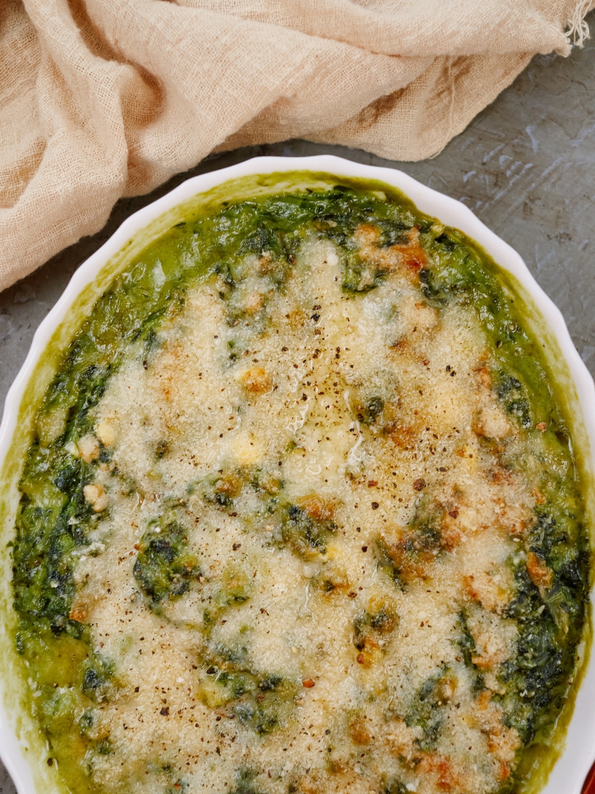 a baking dish with cooked spinach casserole