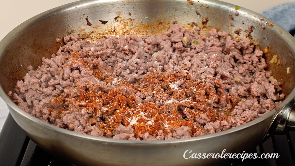 seasonings added to the ground beef in the pan