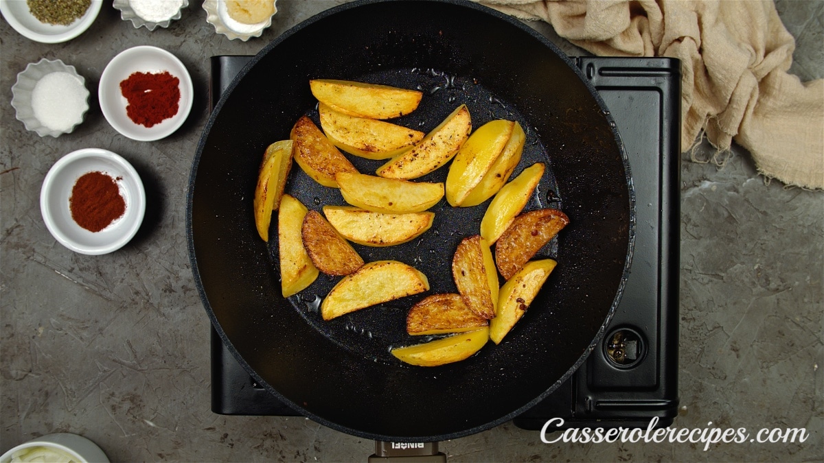 potato wedges browning in skillet