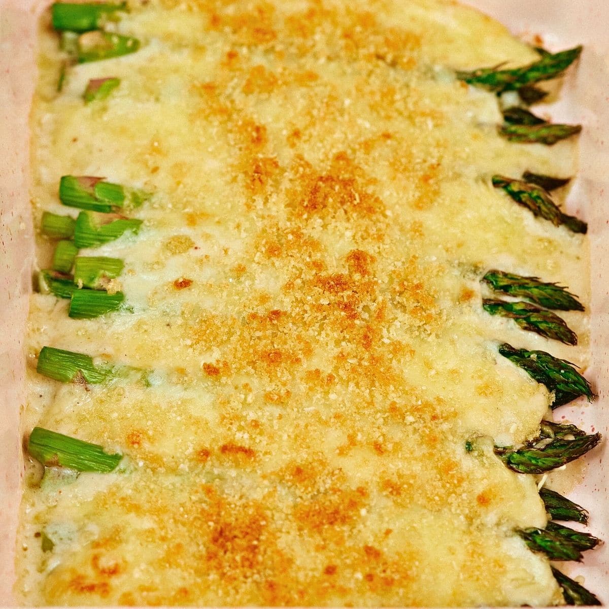 Asparagus casserole freshly baked in a ceramic cooking bowl.