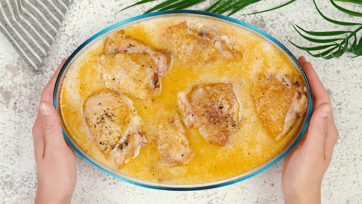 chicken thighs in baking dish in sauce