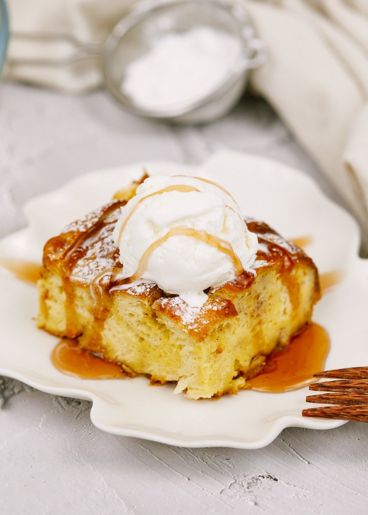 french toast casserole sprinkled with powdered sugar on a plate