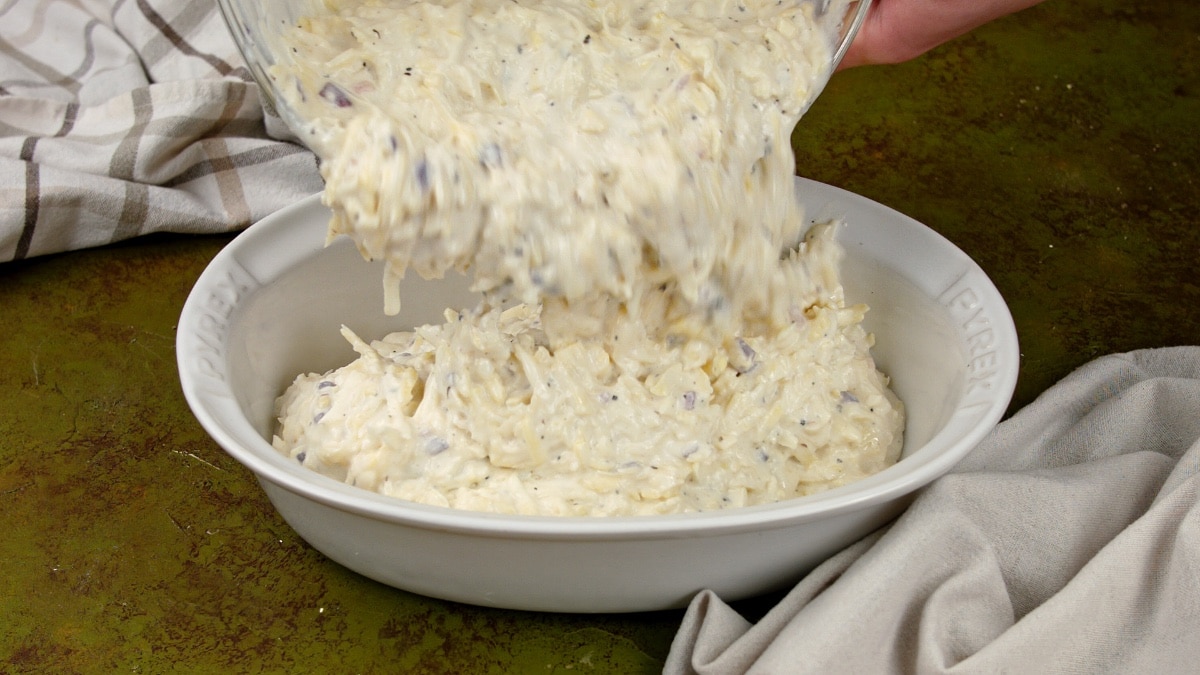pouring hashbrown mixture into baking dish