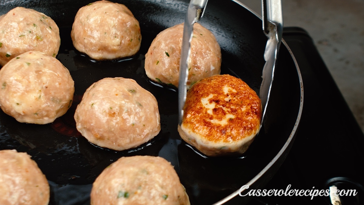 turning meatballs over in pan