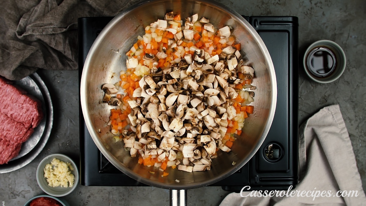 mushrooms added to carrots and onions
