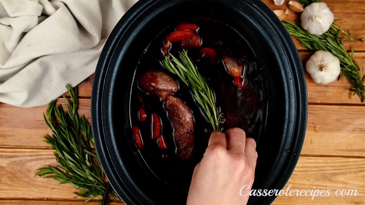 placing rosemary in slow cooker