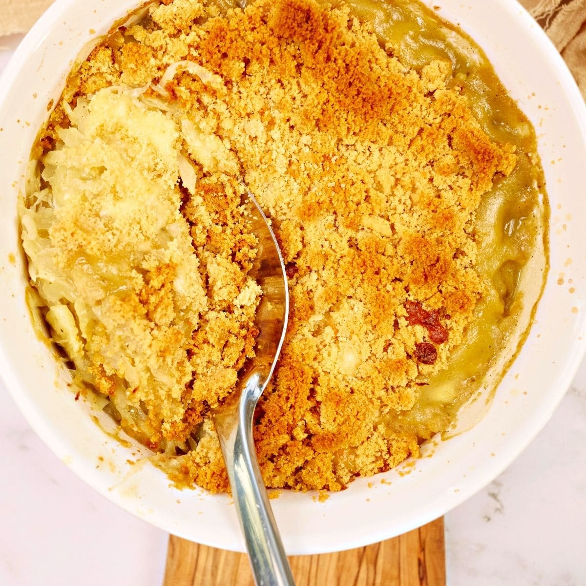 Fresh cabbage casserole in a pink ceramic dish.