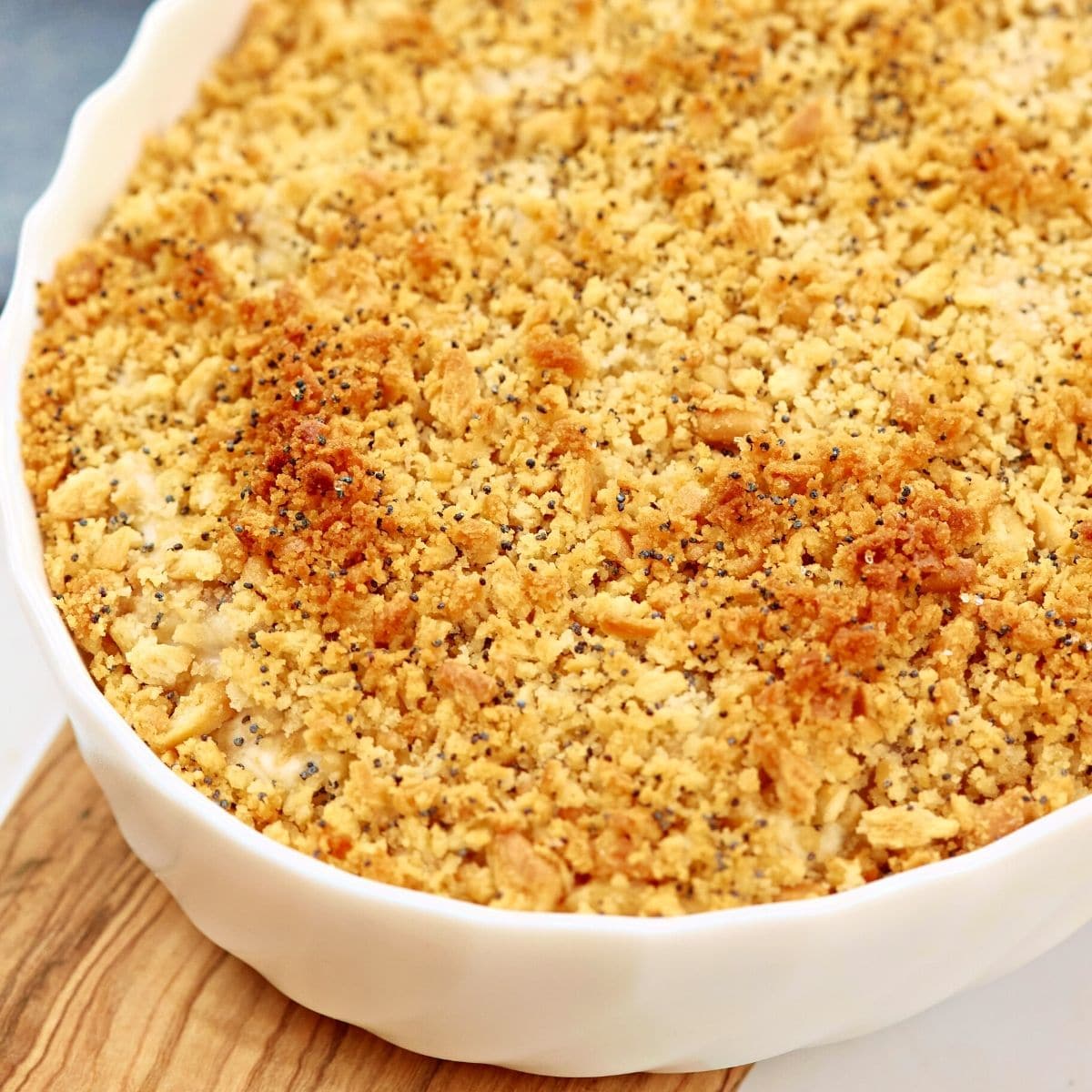 Freshly baked chicken poppy seed casserole in a white ceramic baking dish.