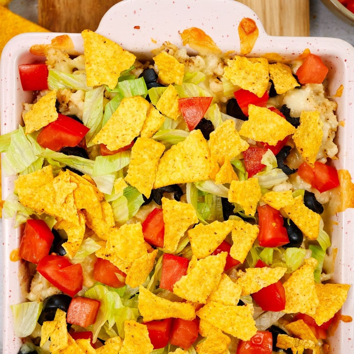 Mexican casserole in a pink ceramic dish.