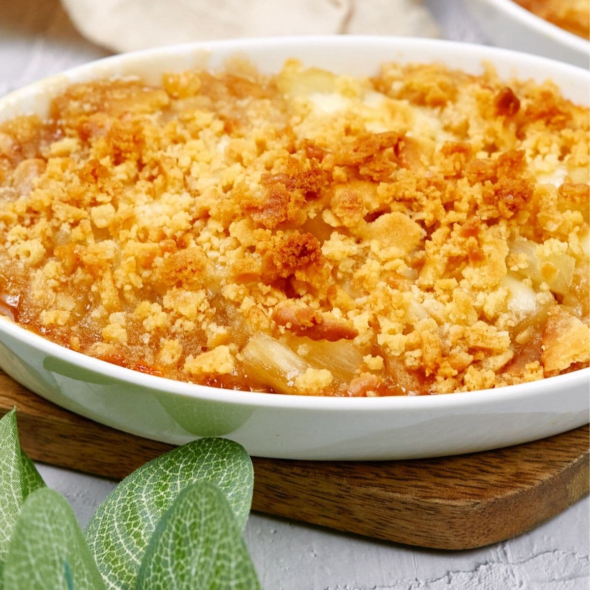 Pineapple casserole served in a white dish.