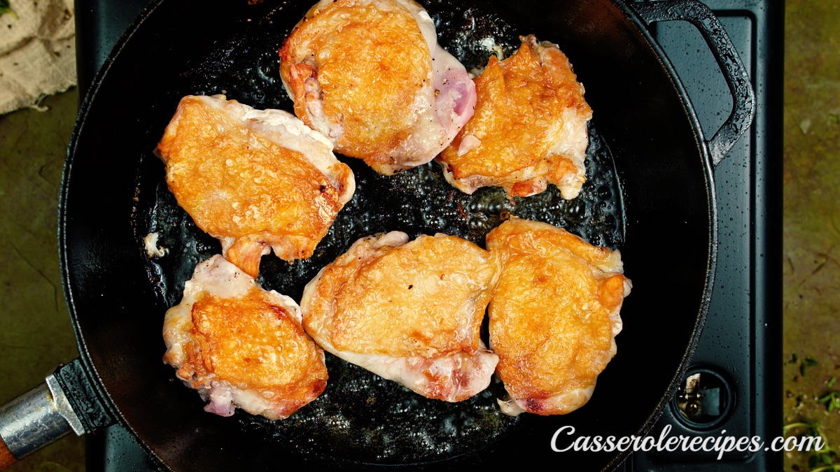 browned chicken thighs in a pan