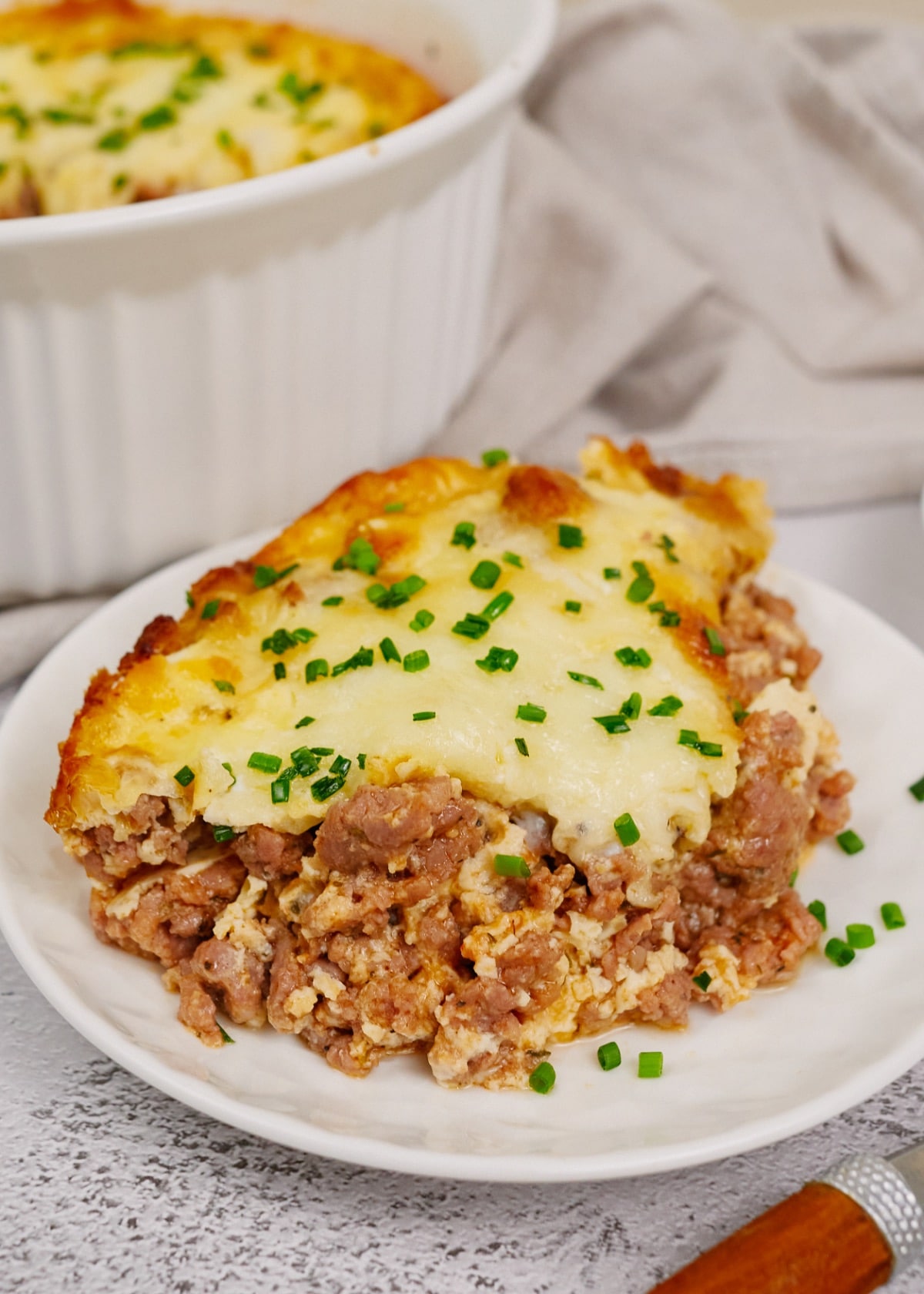 a serving of ground beef casserole on a white plate