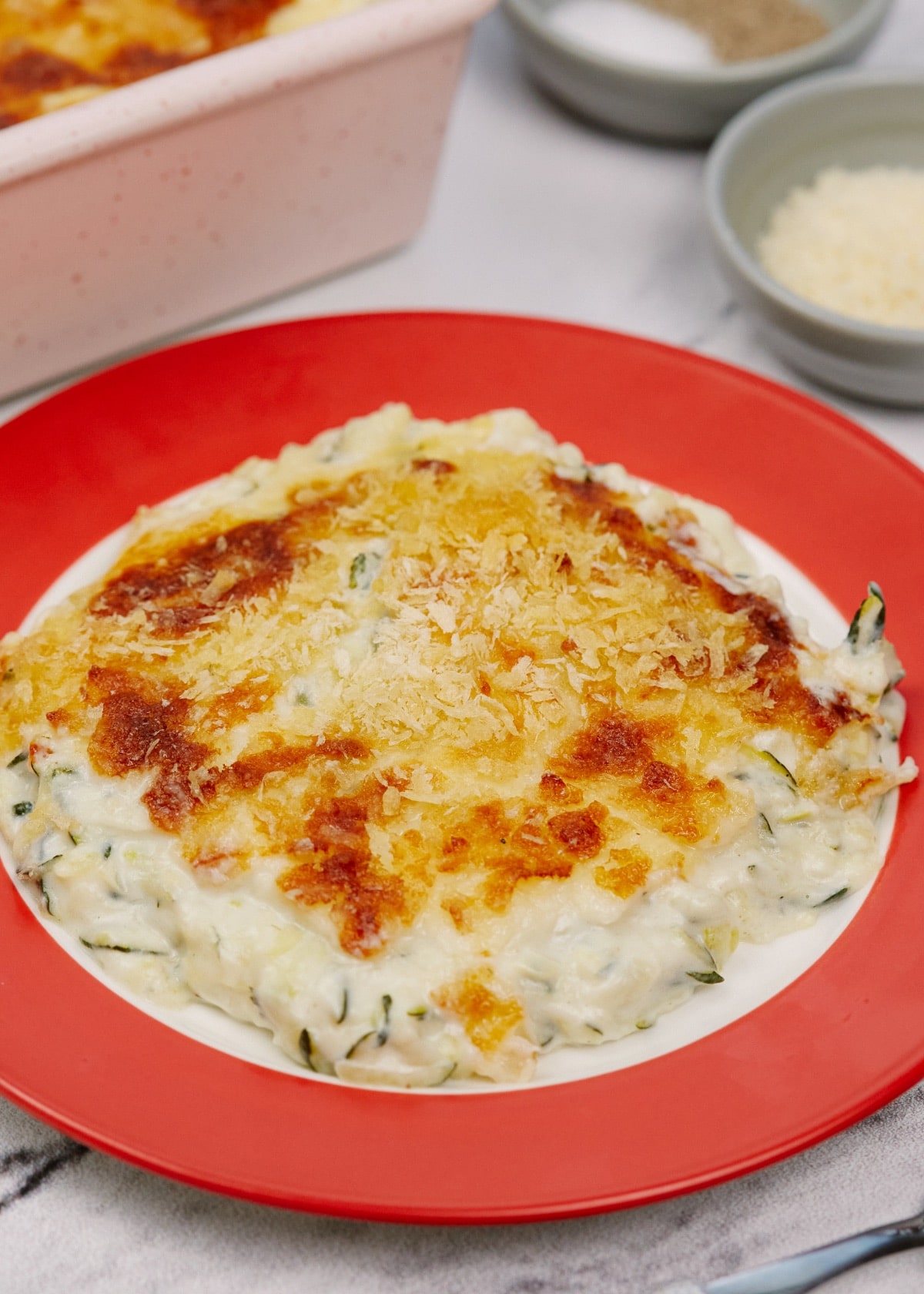 squash casserole on a red plate