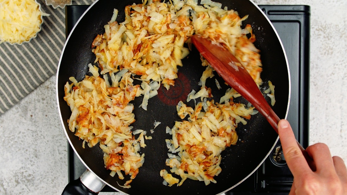 cooking hashbrowns in a pan