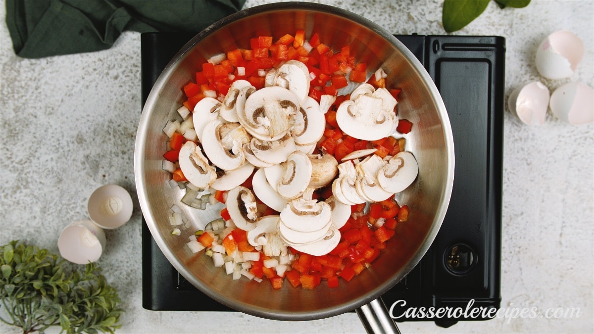 onions, red peppers, and mushrooms in a saute pan