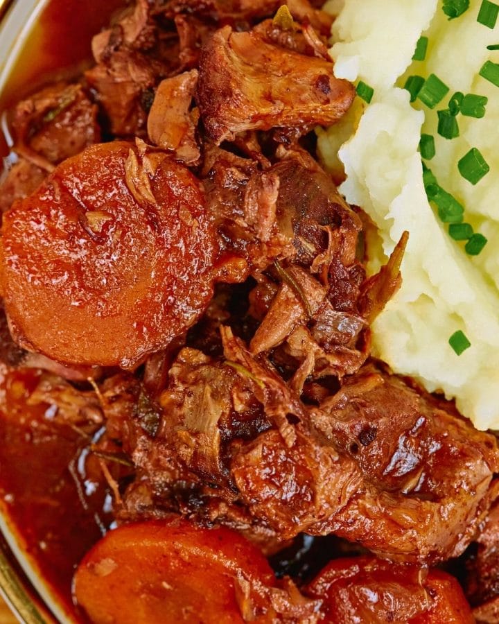 Beef casserole served with mashed potatoes.