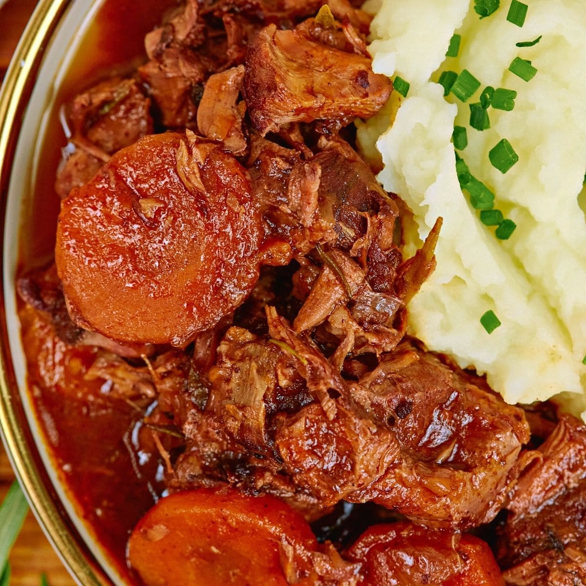 Beef casserole served with mashed potatoes.