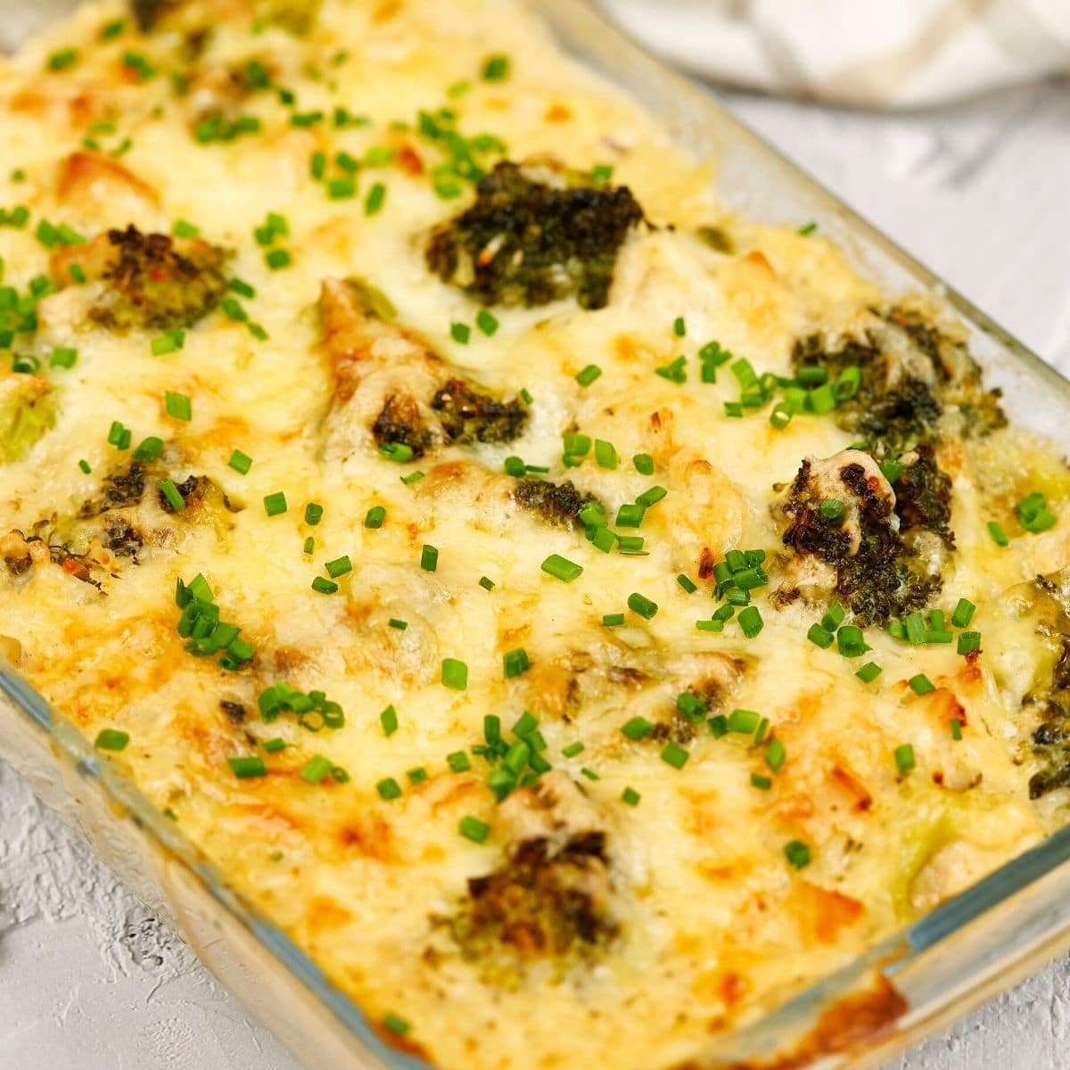 Chicken rice broccoli casserole freshly made in a glass dish.