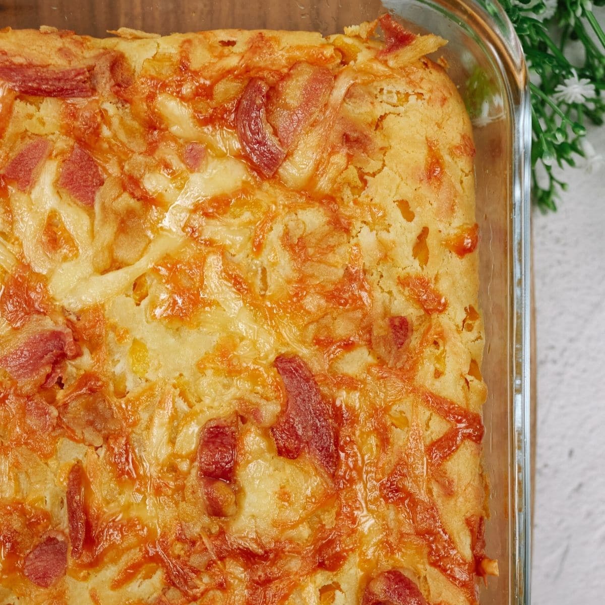 Cornbread casserole in a glass dish.