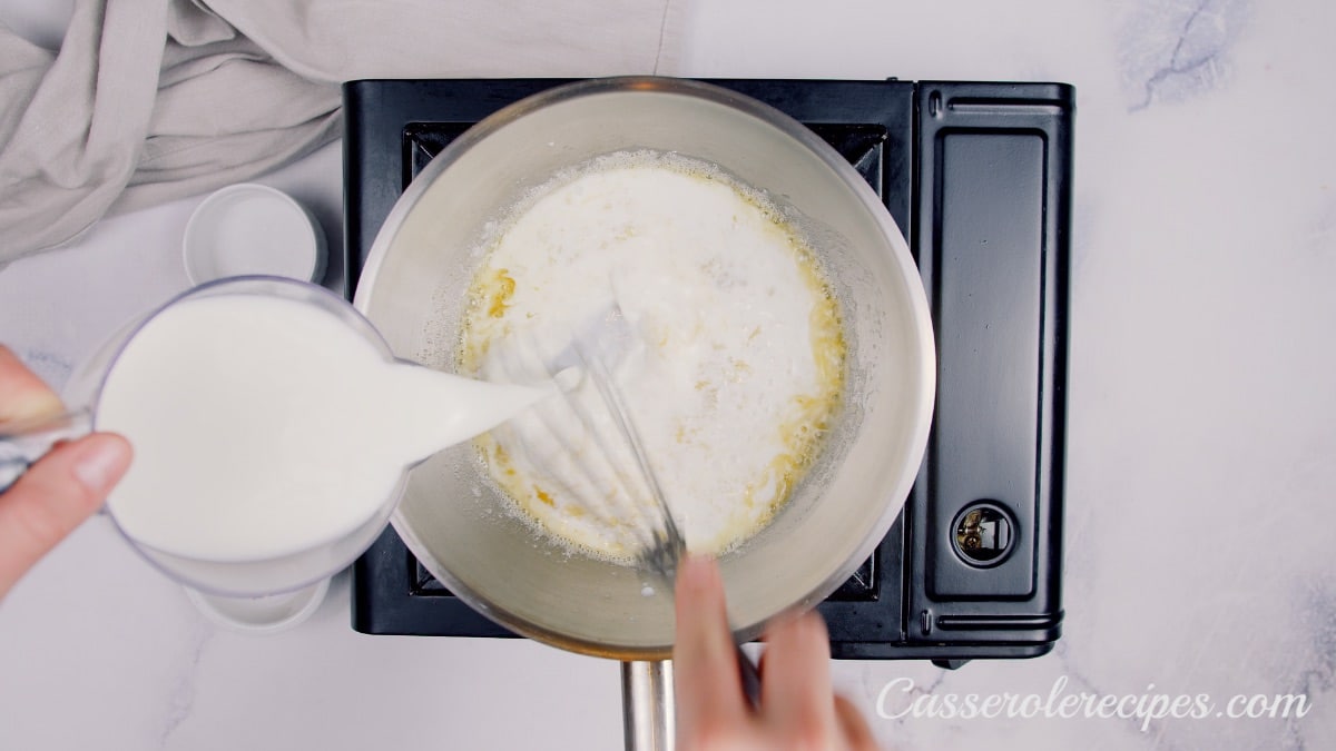 pouring cream into pot with flour and butter