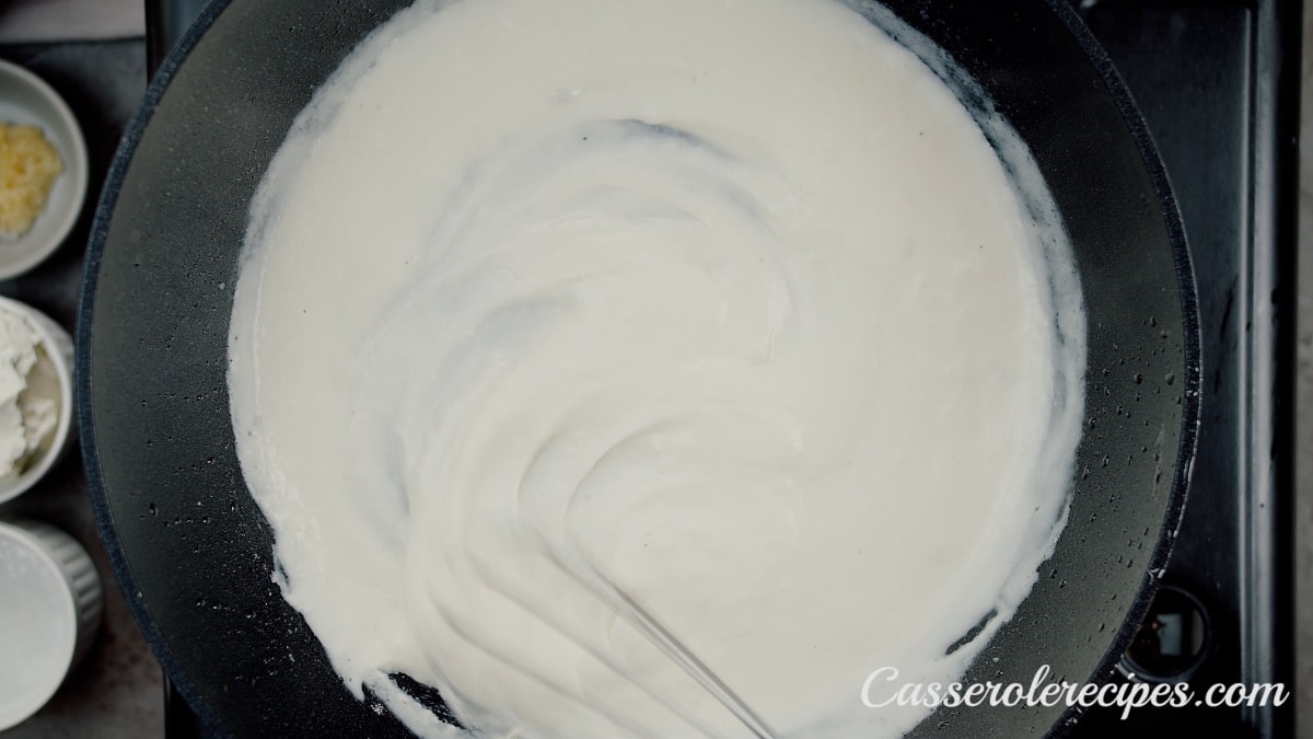 whisking milk into flour with saute pan